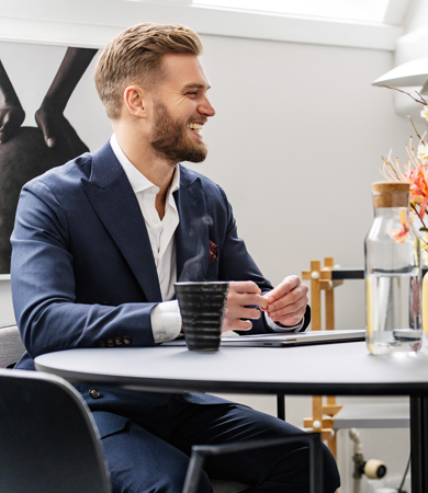 A man and woman sitting beside a black table during a meeting